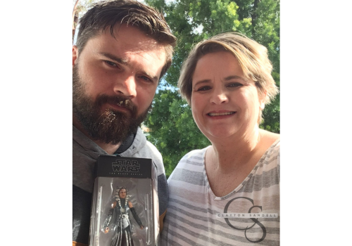 A young man with dark hair and beard next to a woman w/short, blond hair