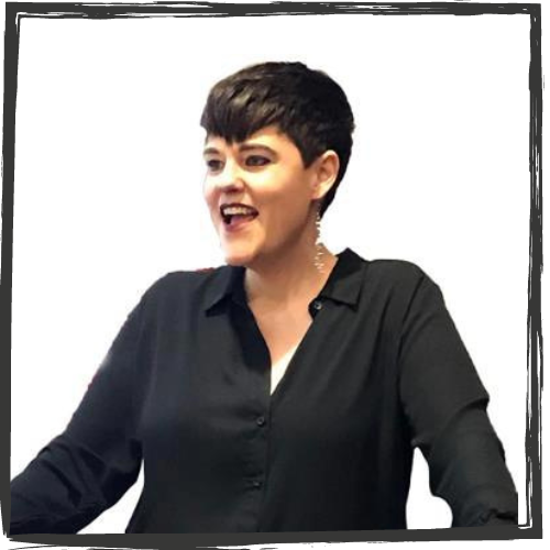 A white woman w/short, black hair & wearing a black blouse