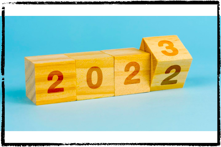 Photo of 4 wood blocks, each with a number: 2, 0, 2 and on the last block a 2 on the lower side & 3 on the upper side