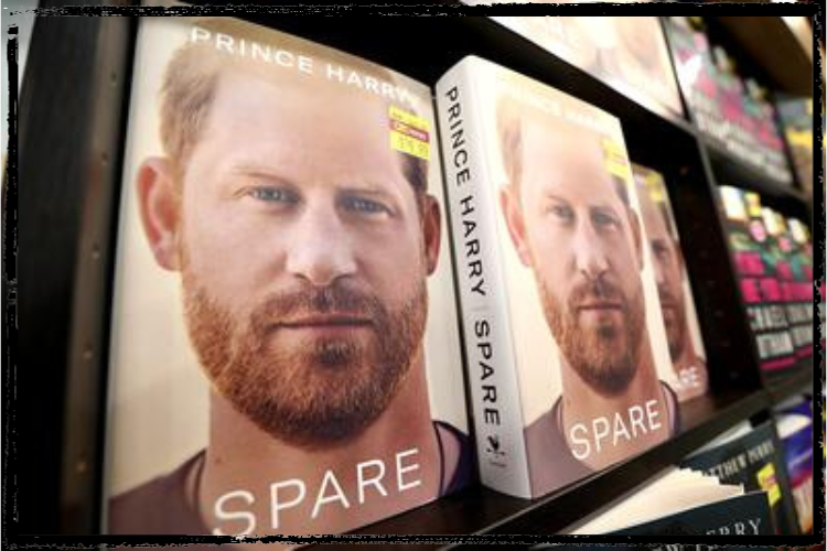 Photo of the cover of Prince Harry's memoir, Spare, featuring a close-up of his face with short, ginger hair & beard