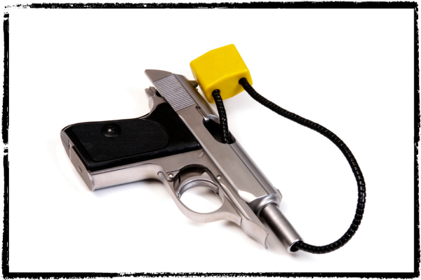 Photo of a silver semi-automatic pistol with a gun lock threaded through the barrel