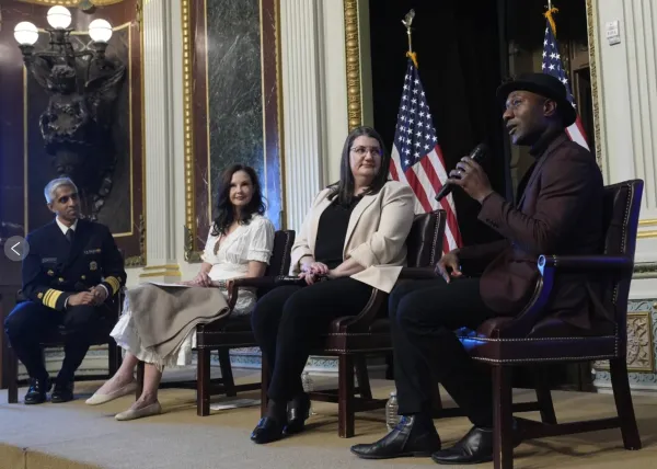 Photo of 4 people sitting on a stage: Dr. Vivek Murthy, Ashley Judd Shelby Rowe and Aloe Blacc speaking