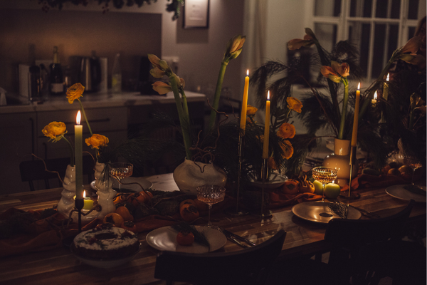 A tablescape lit only by several candles